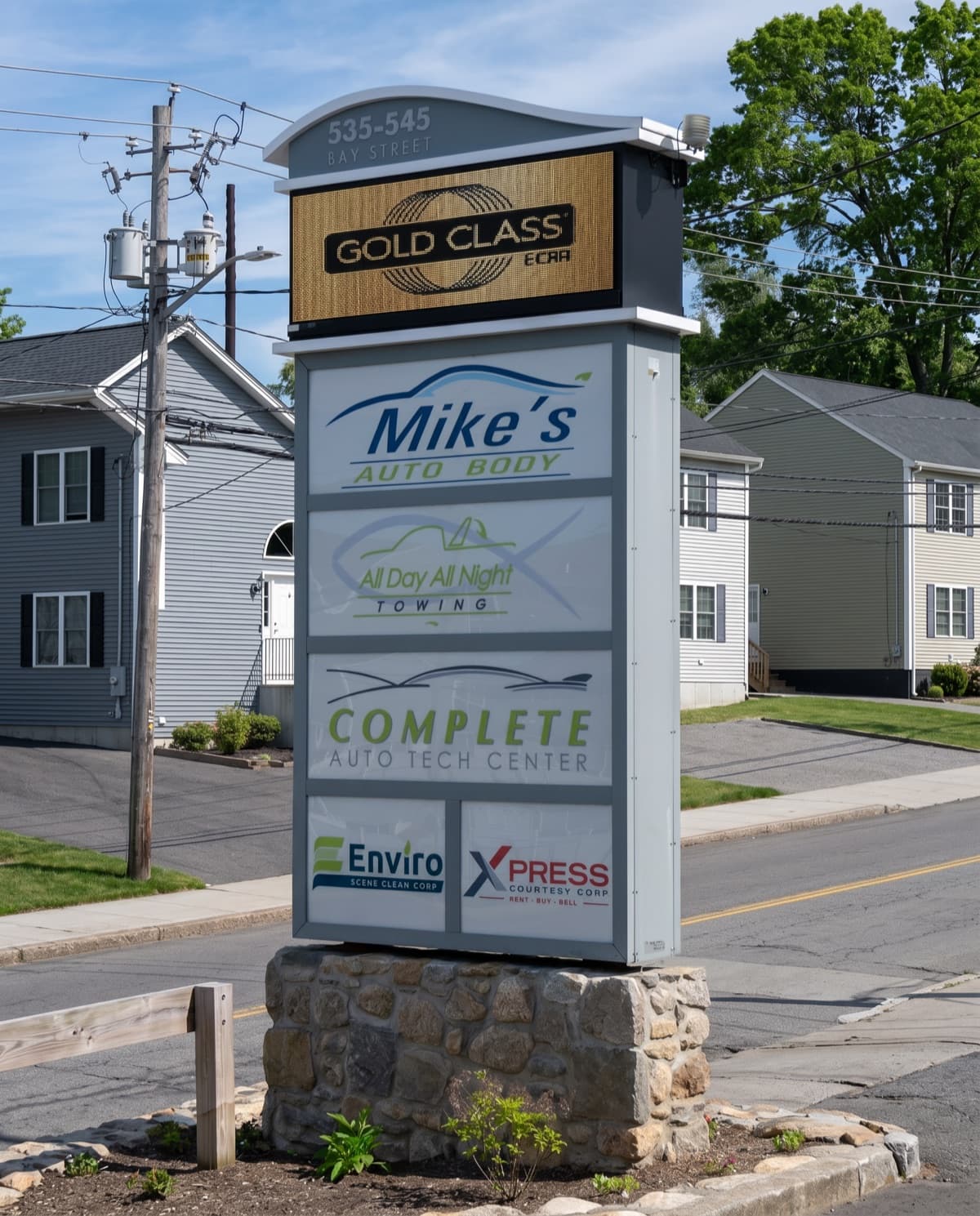 The Complete Auto Tech Center sign at 535 Bay Street, Fall River, alongside the Penacho family businesses