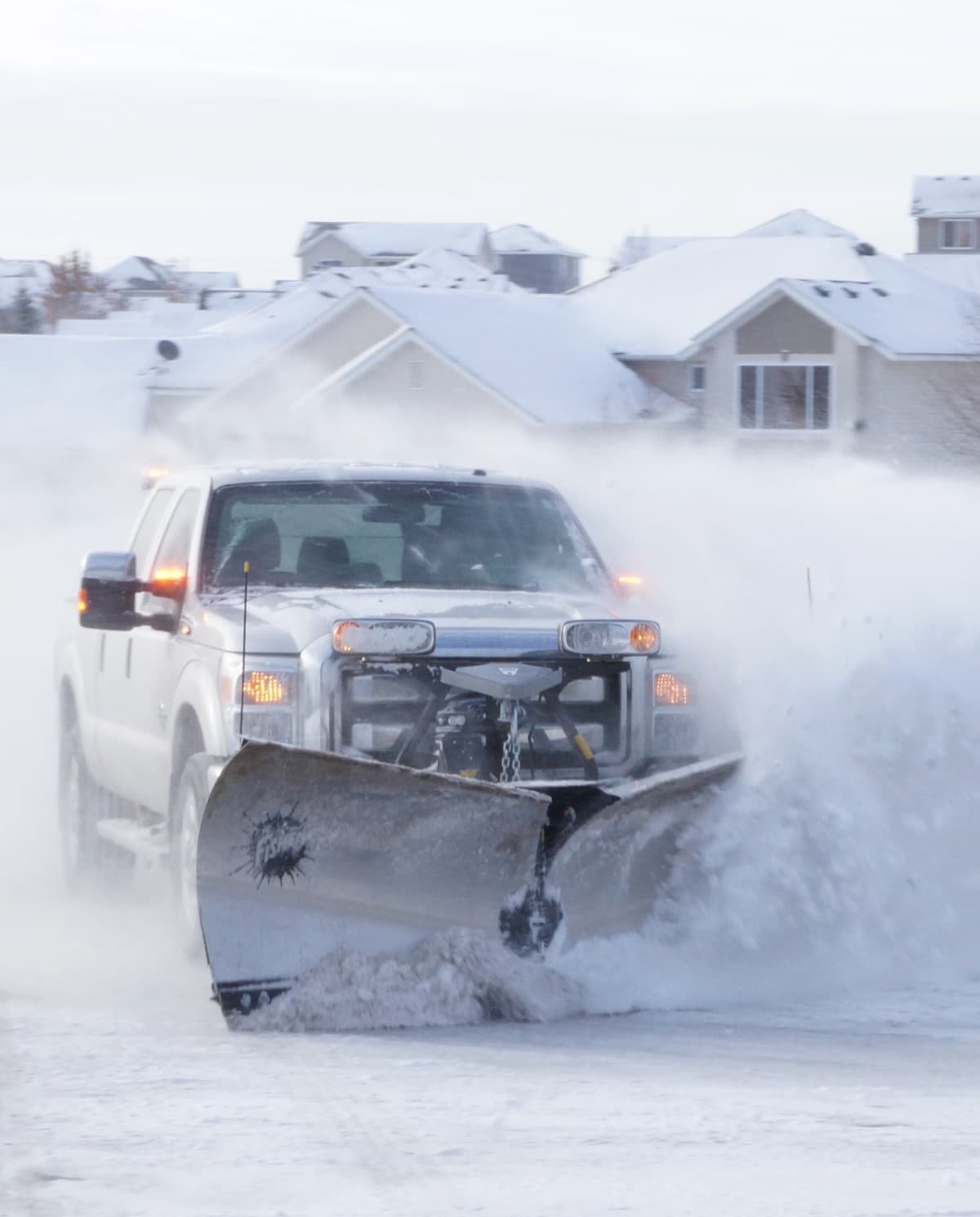 A Fisher snow plow mounted on a truck, ready for the storm, serviced at Complete Auto Tech Center
