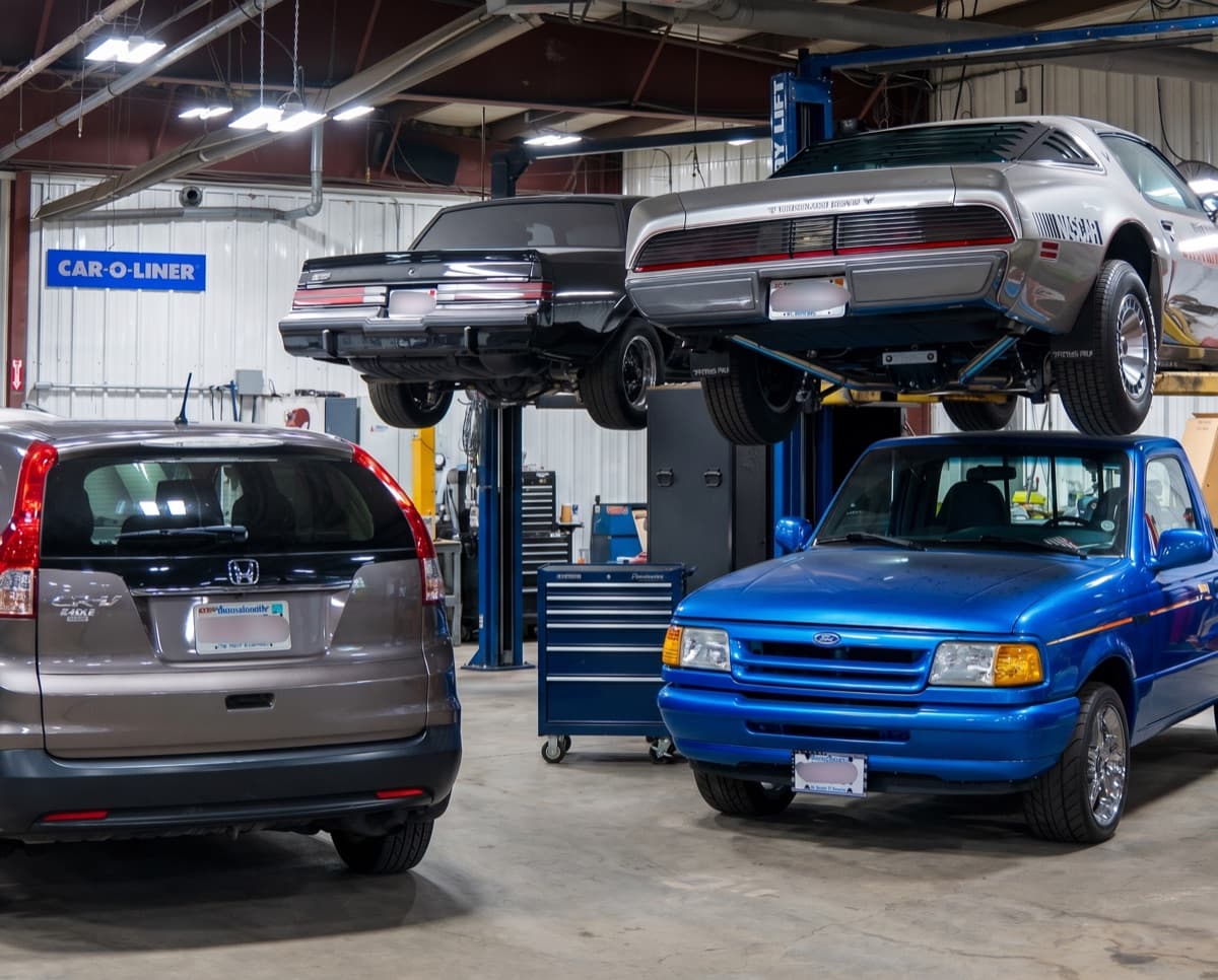 Inside the Complete Auto Tech Center shop, customer vehicles and classics up on the lifts in Fall River